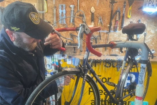 Man repairing broken bicycle